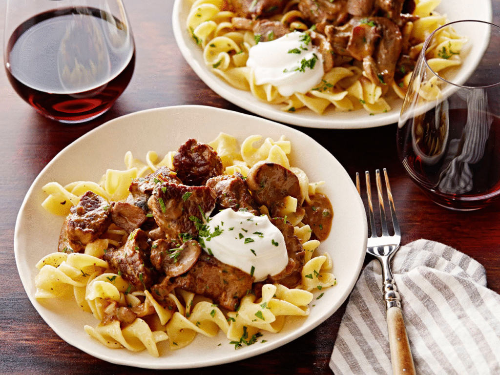 Beef Stroganoff with Buttered Noodles served over egg noodles