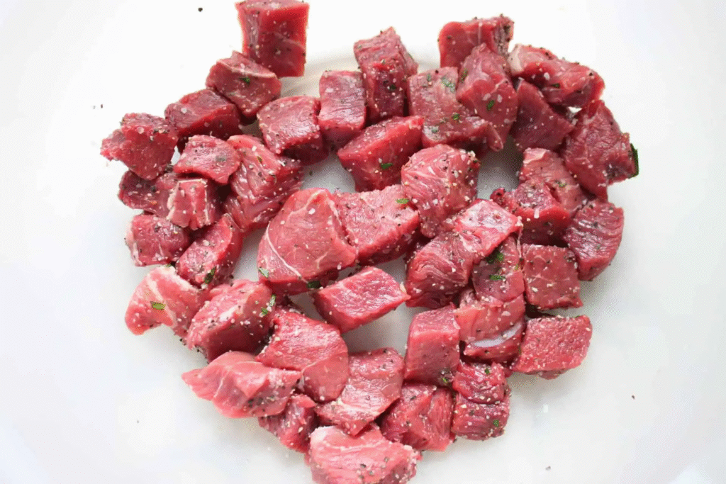 earing beef for Beef Stroganoff with Buttered Noodles in skillet