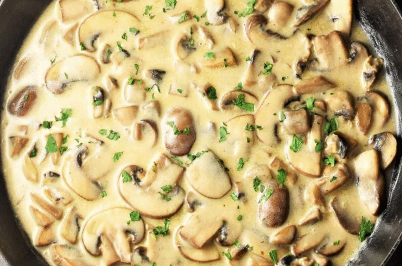 bowl of pan sauce made with sour cream and mushrooms