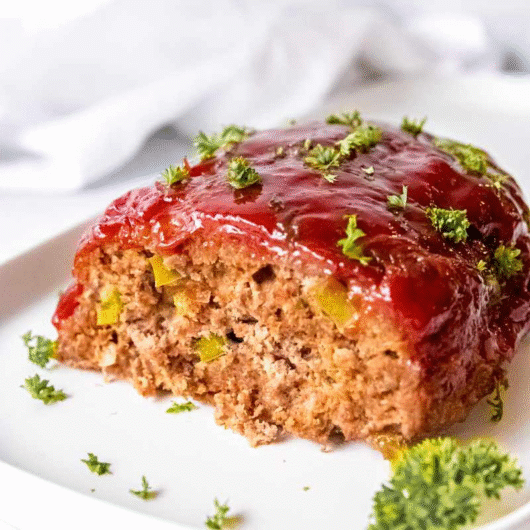 Meatloaf Recipe with tangy glaze and parsley garnish