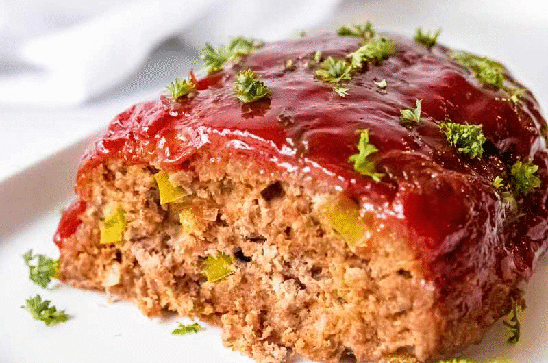 Meatloaf Recipe with tangy glaze and parsley garnish