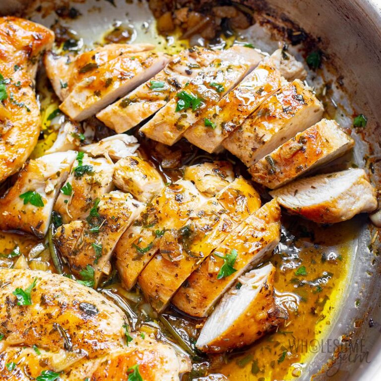 olden pan-seared garlic butter chicken thighs in a creamy herb sauce served in a cast iron skillet